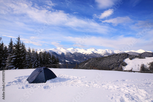 Tourist tent in the winter mountains