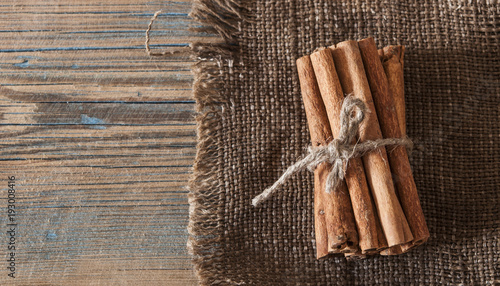 Cinnamon sticks bunch tied with rope on a dark background