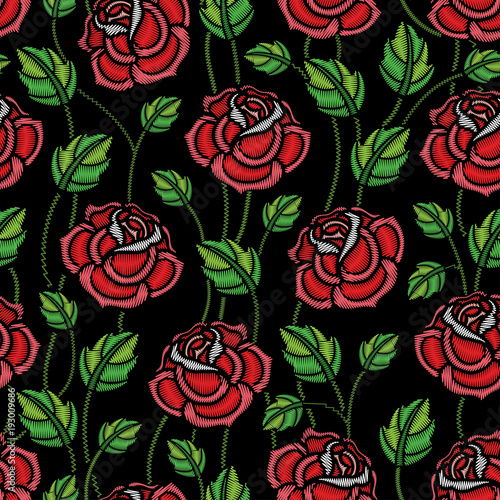 Vector seamless pattern with embroidery red Rose flower and green leaves on the black background. Floral pattern with ornate embroidered roses for clothing decor  fabric and textile design.