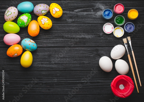 Happy Easter. Painting eggs for Easter holiday on wooden table.