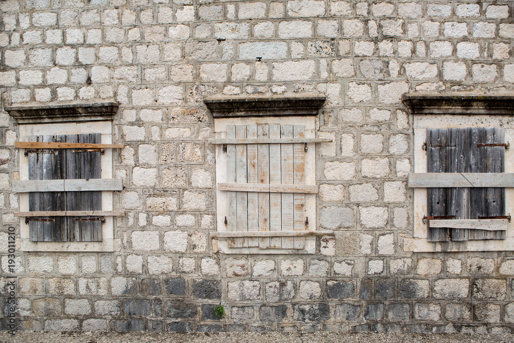boarded-up Windows in an old stone building