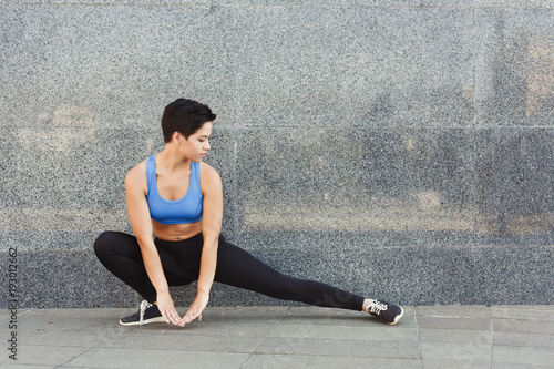 Fitness woman at stretching training outdoors