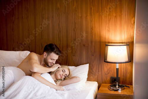 Loving young couple in the bed