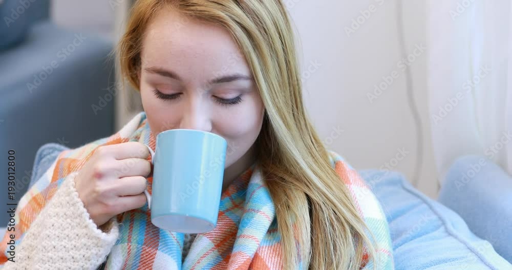 Portrait of a woman relaxing at home with a cup of tea Portrait of a woman relaxing at home with a cup of tea