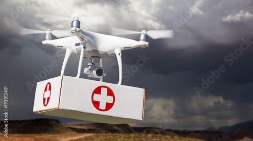Unmanned Aircraft System (UAV) Quadcopter Drone Carrying Package First Aid Symbol Label Near Stormy Skies.