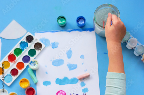  A child draws at a table in a kindergarten.