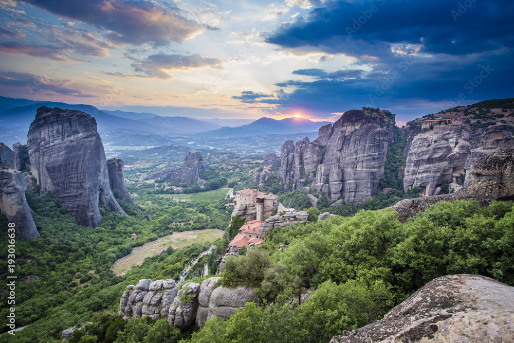 Sunset at Meteora with monastries situated above limestone rock pillars