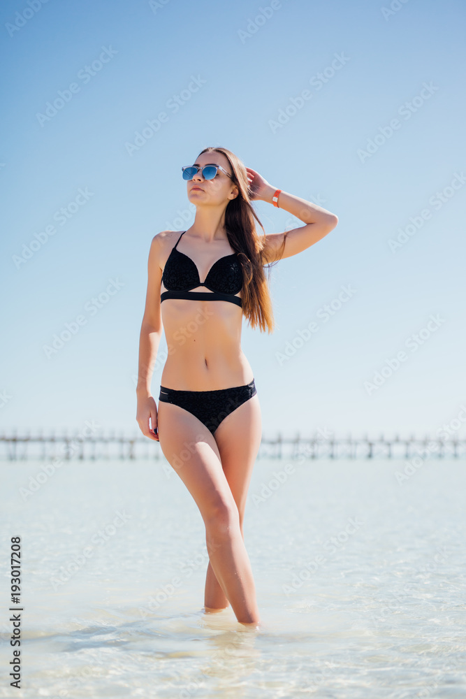 Canvas Print Young slender woman in fashionable swimsuit 