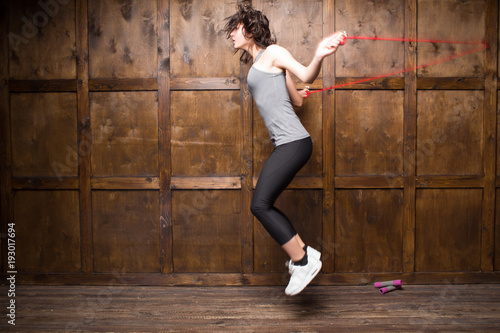 Side view image of girl with rope. Sport concept.