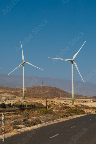 electric wind turbines farm, blue sky background