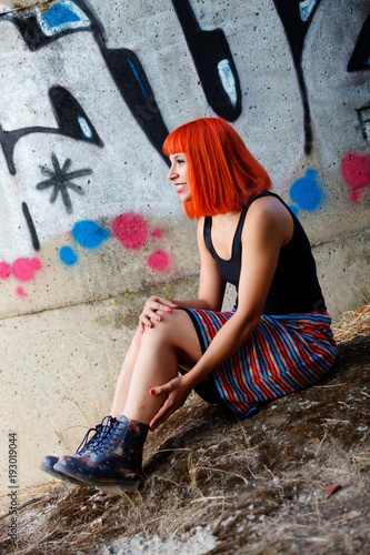 Attractive girl with red hair in the street