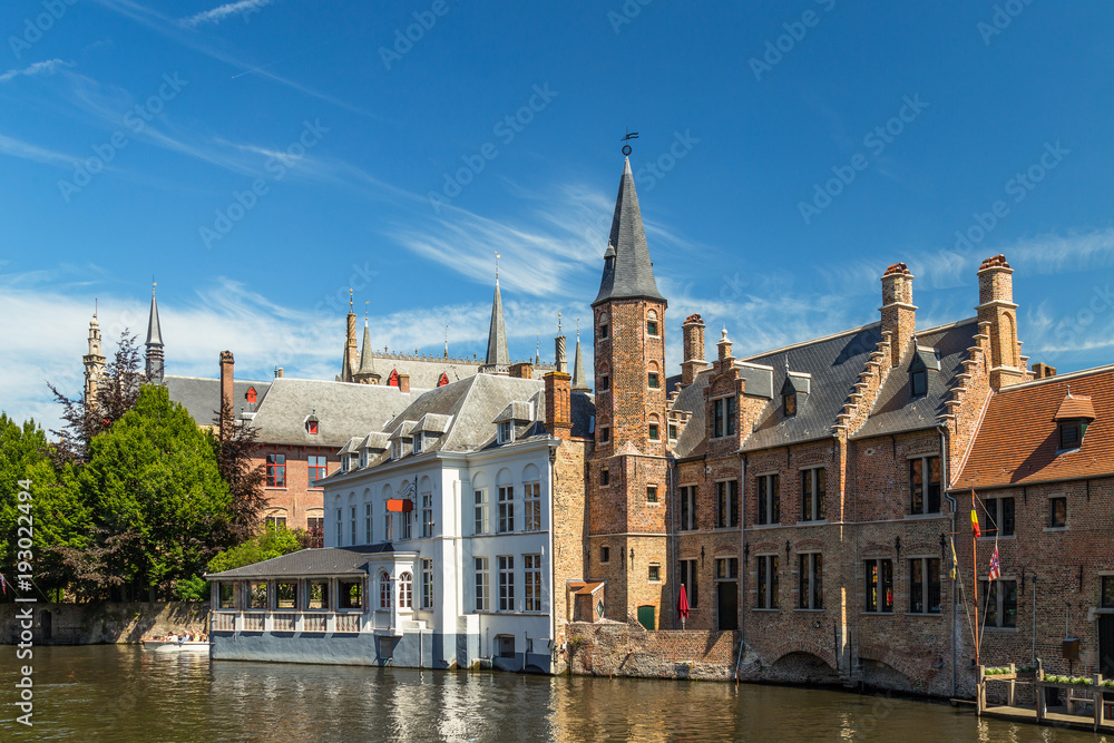 Typical medieval Flemish architecture of Bruges, Belgium. Red brick houses standing on the banks of canals.