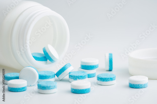blue and white pills medicine on white background.