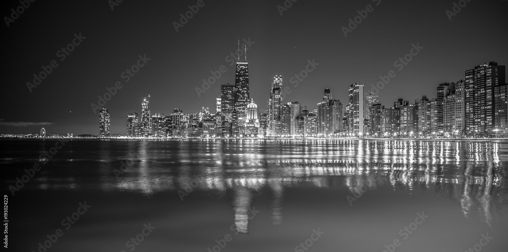 Big city skyline on water at night