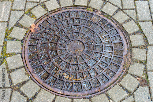 Round manhole cover on the footpath