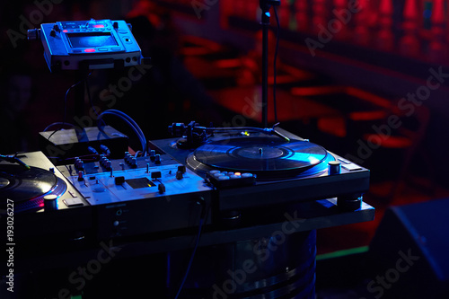 Closeup of a DJ keypad with vinyl records.