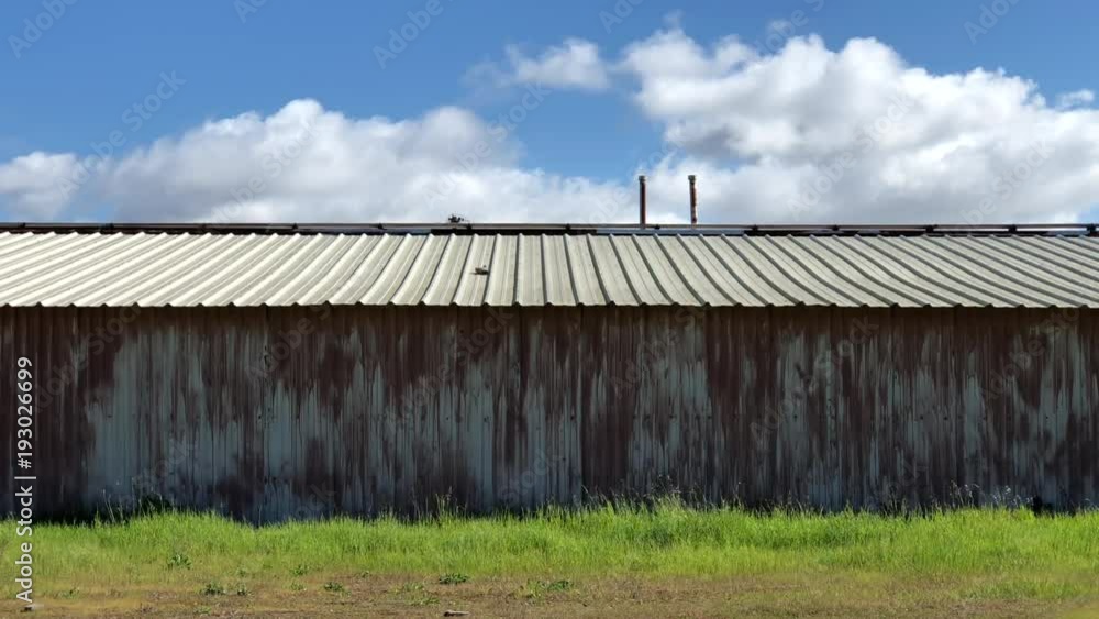4K HD Video of wind blowing clouds and grass, zooming into grass blowing in strong wind.