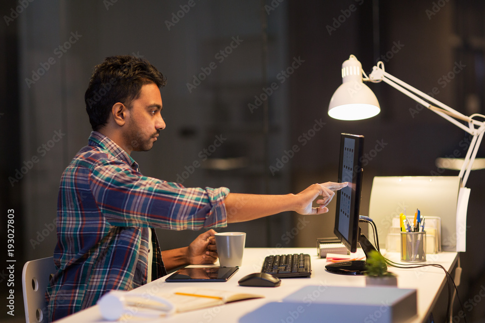Fototapeta premium creative man with computer working at night office