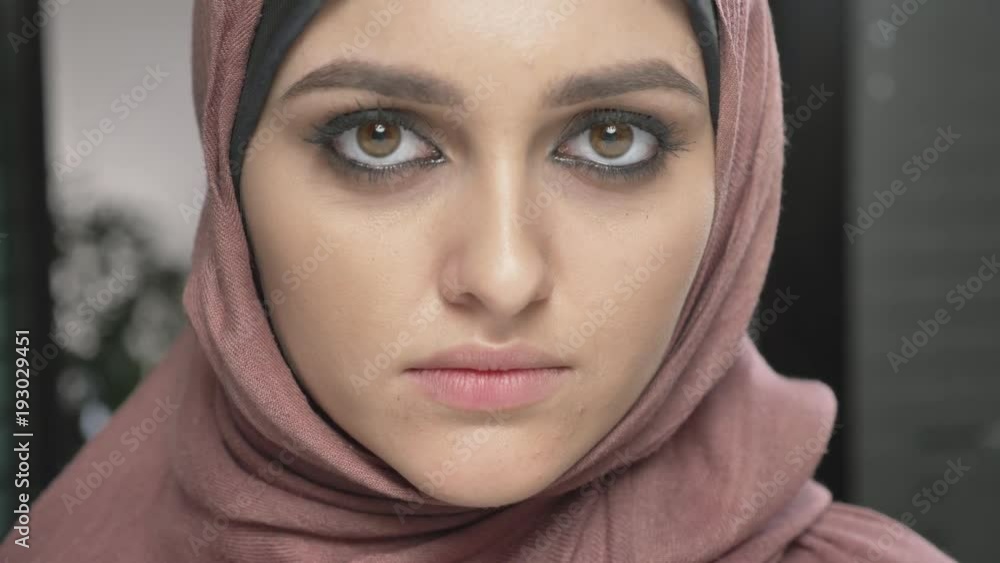 Young beautiful girl in pink hijab smiling and looking at camera. Portrait, close up 60 fps Young beautiful girl in pink hijab smiling and looking at camera. Portrait, close up 60 fps