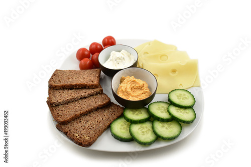 Healthy plate stock images. Slice of cheese with garnish. Platter isolated on a white background. Healthy snack images