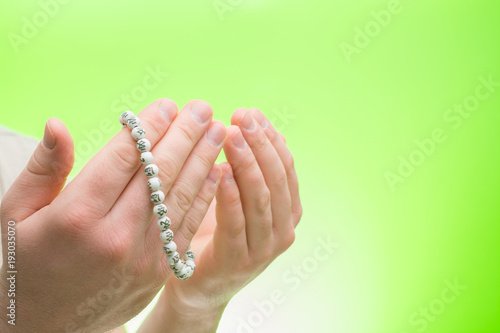 Hands with Muslim beads. Man praying