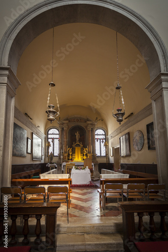 Modest interior of one of the many Catholic churches in Venice  Italy. An ancient interiors in a traditional style with paintings on the walls