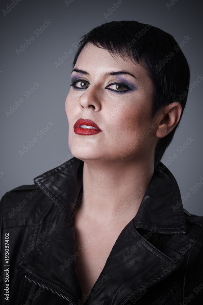 Androgyne, Brunette woman dressed in leather jacket, androgynous  appearance, beauty and short hair Photos | Adobe Stock