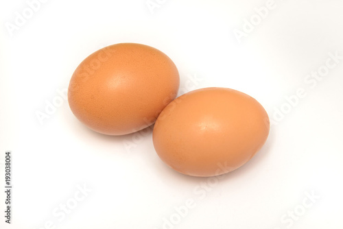 Two chicken eggs on a white background