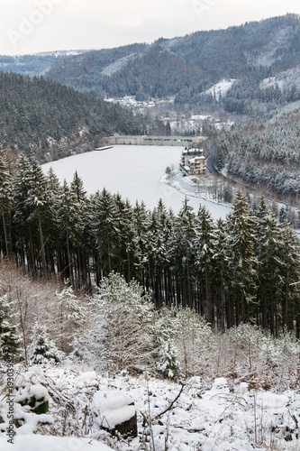 Aerial view of concrete Brezova dam with hydroelectric power plant and road to Karlovy Vary from Jungmann gazebo, snowy winter day, Czech Republic photo