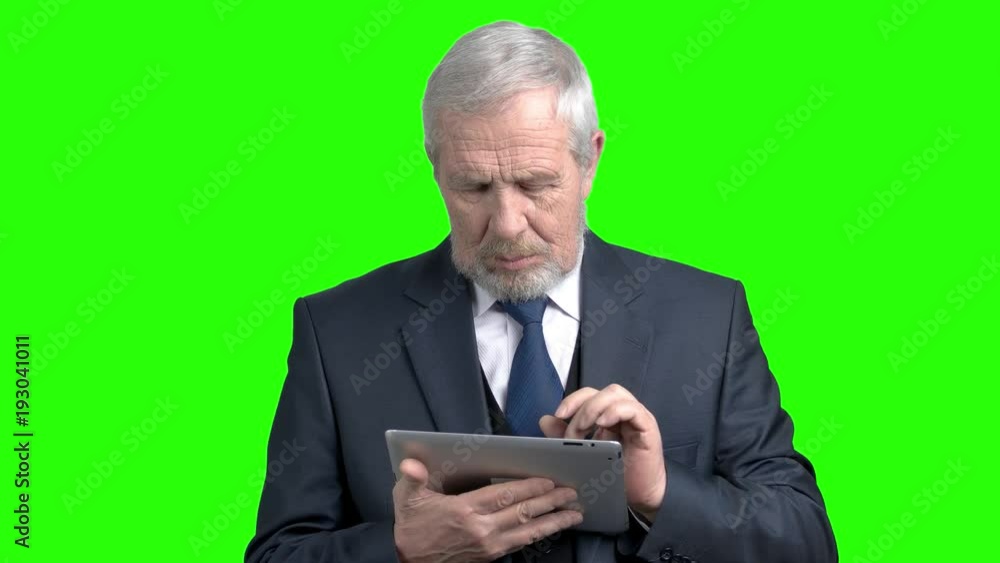 Elderly businessman having an idea. Senior grey haired entrepreneur working on digital tablet, alpha channel background. Business people and modern technology. Elderly businessman having an idea. Senior grey haired entrepreneur working on digital tablet, alpha channel background. Business people and modern technology.
