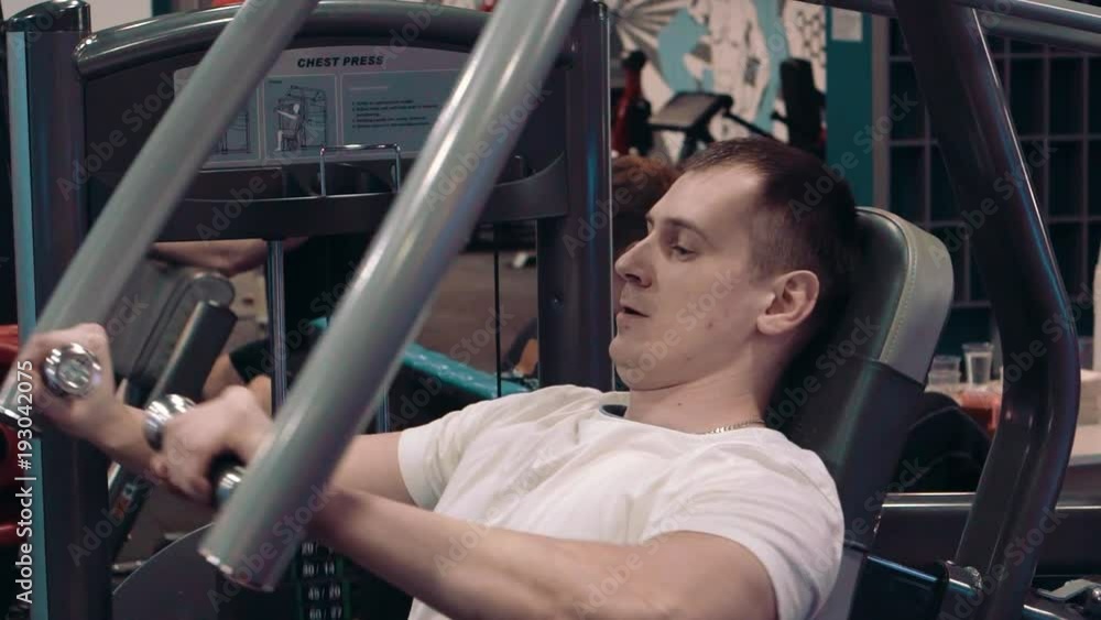 the young guy is engaged in an exercise room the young guy is engaged in an exercise room