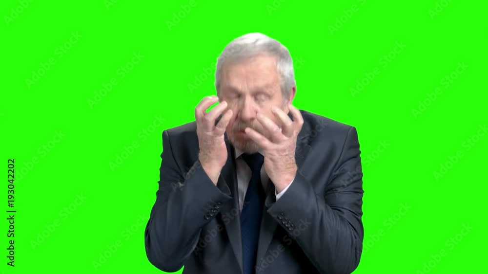 Shocked elderly businessman, green screen. Senior businessman holding his head in shock and surprise, chroma key background. Anxiety and trouble concept. Shocked elderly businessman, green screen. Senior businessman holding his head in shock and surprise, chroma key background. Anxiety and trouble concept.
