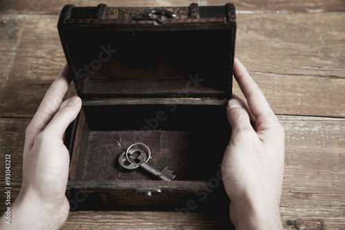 man hand wooden box and key photo