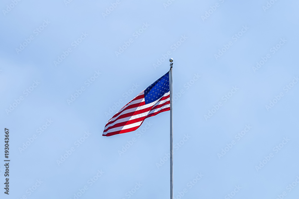 United States of America Flag over a clear blue sky backgound