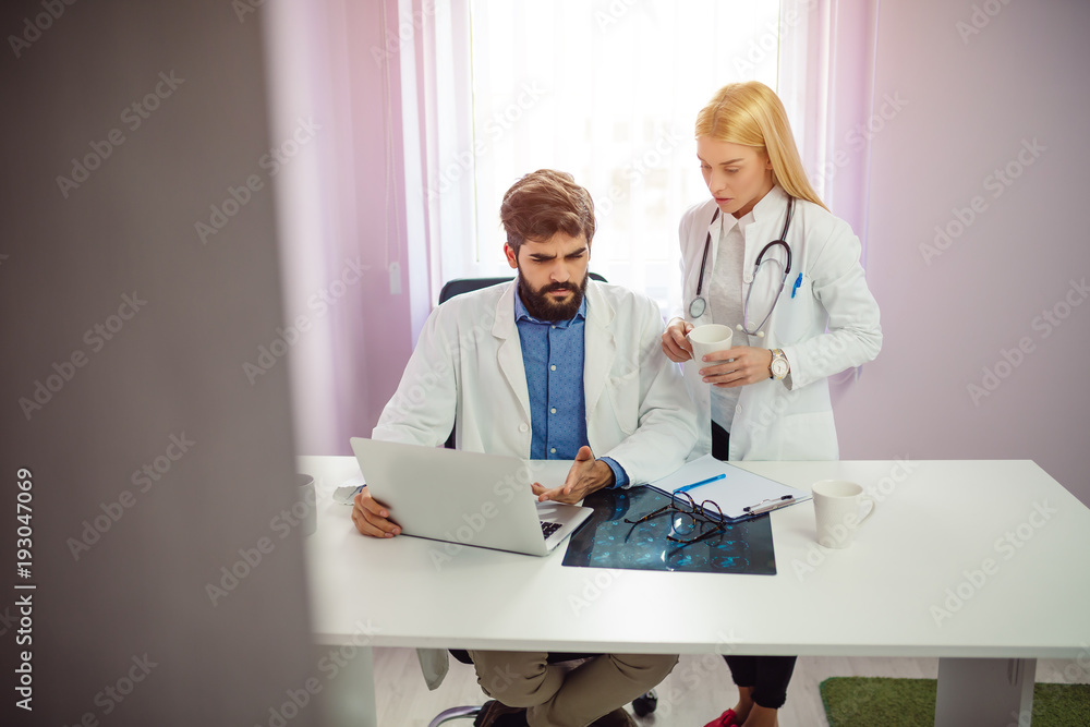 Male and female doctor having discussion in hospital. Male and female doctor having discussion in hospital.