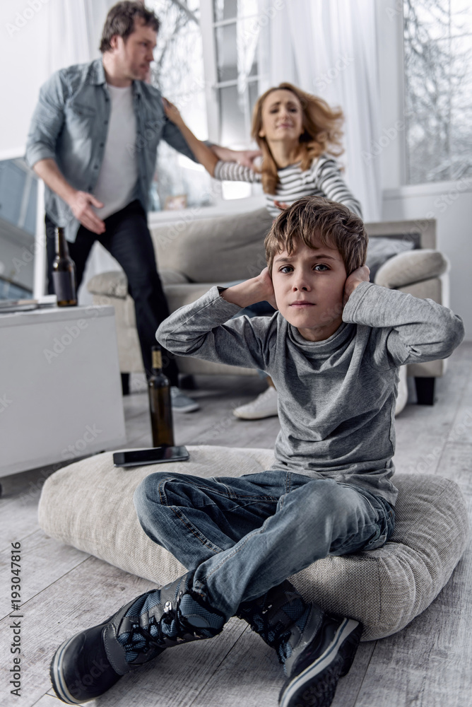 © Viacheslav Yakobchuk - Stop it. Furious emotional married people having an awful loud quarrel while their little scared worried son sitting not far from them and closing his ears © Viacheslav Yakobchuk - Stop it. Furious emotional married people having an awful loud quarrel while their little scared worried son sitting not far from them and closing his ears