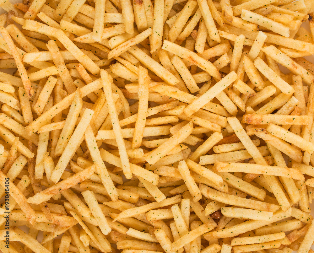Potato chips, natural fried golden potato with spices, fast food, background, top view Potato chips, natural fried golden potato with spices, fast food, background, top view