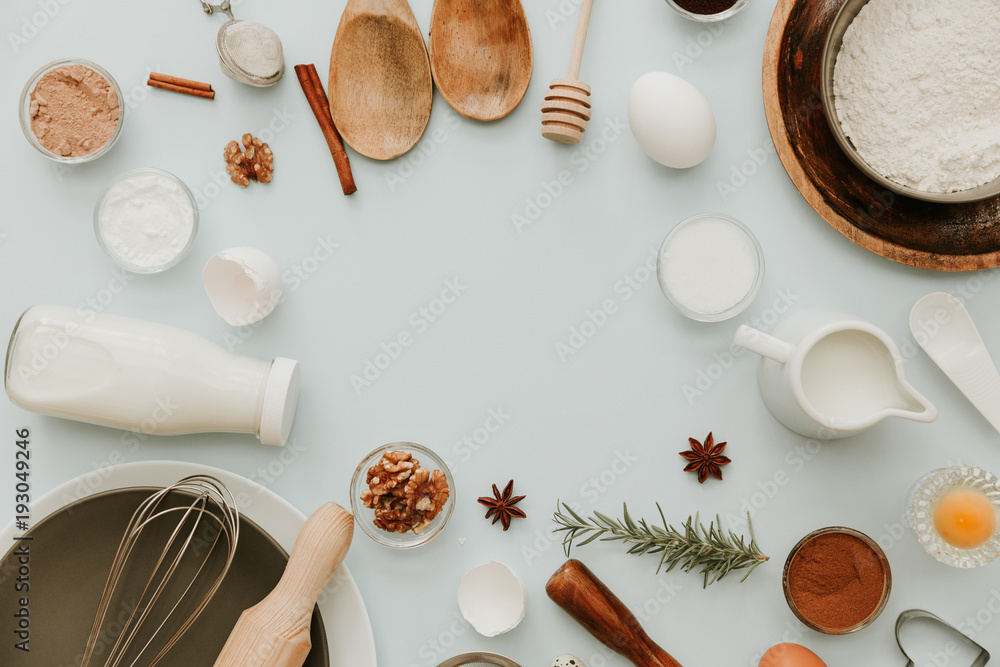 Baking utensils and recipe ingredients on pastel light blue background ...