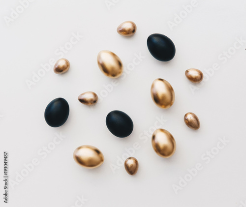 Flat lay black and gold eggs. Minimal easter background