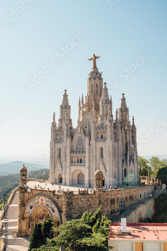 Tibidabo church on mountain in Barcelona with christ statue photo