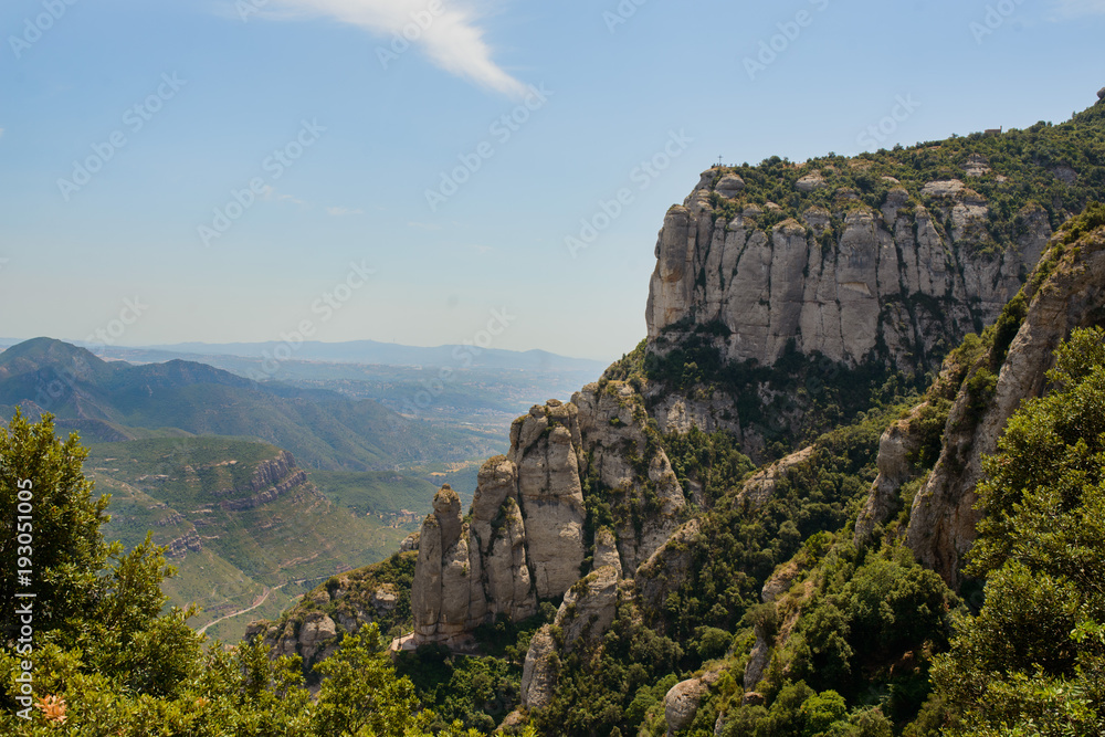 A mountain view with monastery on the top in Montserrat, Spain A mountain view with monastery on the top in Montserrat, Spain