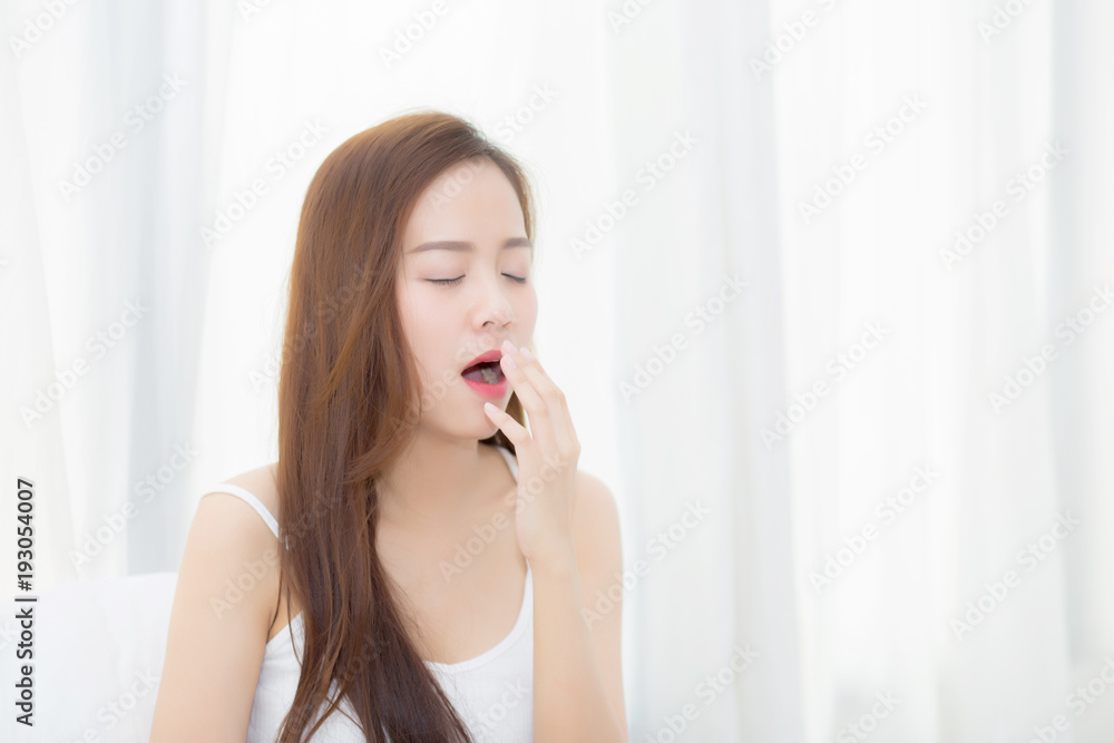 Beautiful young asian woman yawn sitting with sleep on bed at bedroom, girl wake up after resting and leisure with wellness, lifestyle concept. Beautiful young asian woman yawn sitting with sleep on bed at bedroom, girl wake up after resting and leisure with wellness, lifestyle concept.