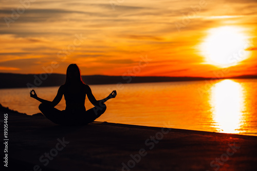 Carefree calm woman meditating in nature.Finding inner peace.Yoga practice.Spiritual healing lifestyle.Enjoying peace,anti-stress therapy,mindfulness meditation.Positive energy.Lotus pose © eldarnurkovic