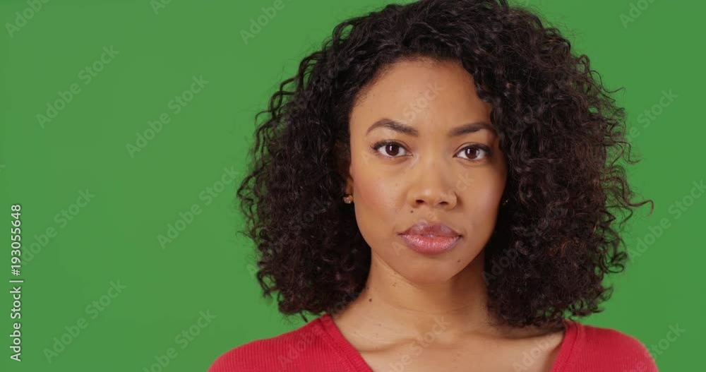 Close up portrait of pretty black woman looking directly at camera on greenscreen background. Close-up of serious African American millennial on green screen for keying or compositing. 4k Close up portrait of pretty black woman looking directly at camera on greenscreen background. Close-up of serious African American millennial on green screen for keying or compositing. 4k