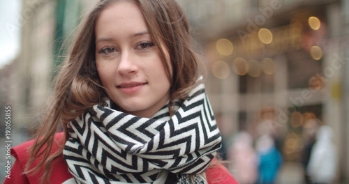 Wallpaper Mural Portrait of beautiful young woman standing in a city street and smiling. Torontodigital.ca