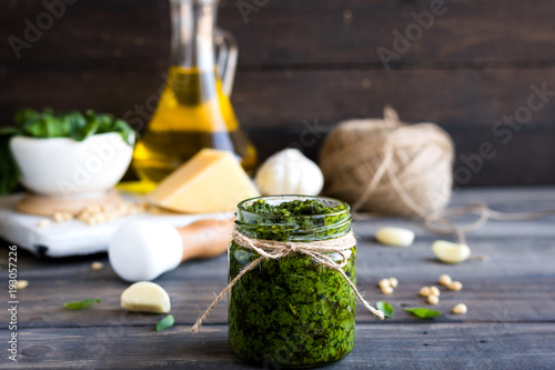 Fresh homemade pesto sauce and ingredients to it