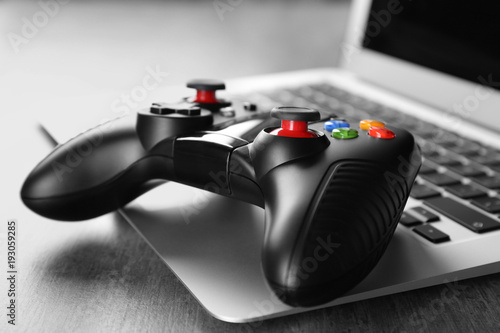Video game controller on laptop, closeup