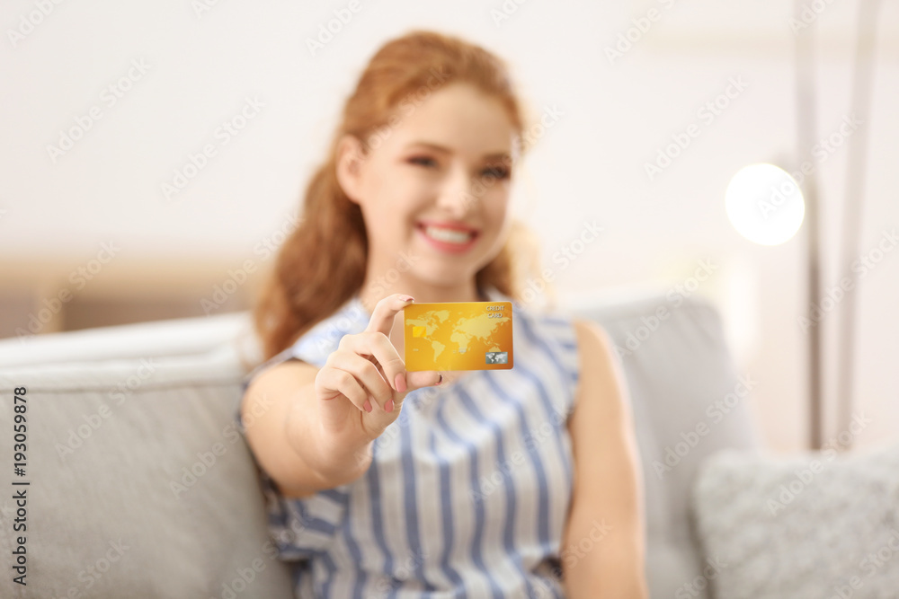 Young woman with credit card at home. Online shopping Young woman with credit card at home. Online shopping