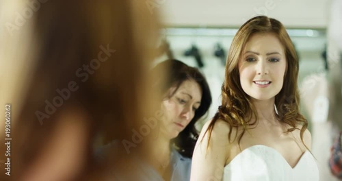 Wallpaper Mural 4k, An attractive young woman in bridal shop with a dress designer in a shop. Slow motion. Torontodigital.ca