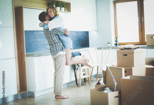 Portrait of young couple moving in new home. Young couple